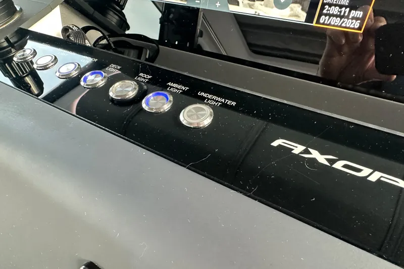 Slide: The Image of Control panel of 2022 Axopar 37 XC Cross Cabin with various light switches. - 3