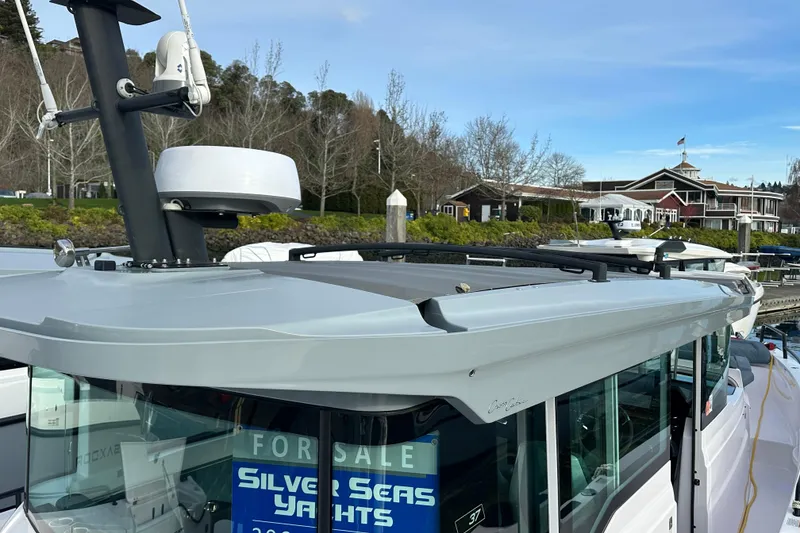 Slide: The Image of 2022 Axopar 37 XC Cross Cabin yacht for sale at marina, Silver Seas Yachts sign visible. - 8