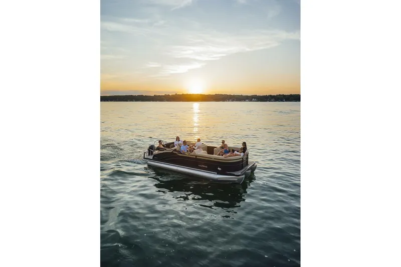 Slide: The Image of 2023 Harris Sunliner 230 Sport boat dashboard with steering wheel and navigation display. - 10