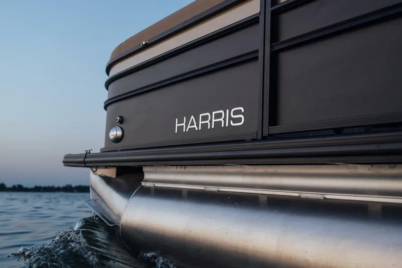Slide: The Image of 2023 Harris Sunliner 230 Sport boat interior with luxurious seating and cup holders. - 13