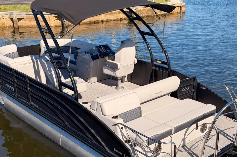 Slide: The Image of 2023 Harris Sunliner 230 Sport pontoon boat with sleek design and comfortable seating. - 24