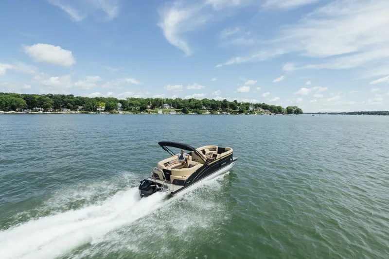 Slide: The Image of 2023 Harris Sunliner 230 Sport pontoon boat on a sunny day by the water. - 4