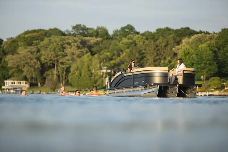 Slide: The Image of Luxurious seating on 2023 Harris Sunliner 230 Sport boat, featuring elegant upholstery and cup holders. - 6