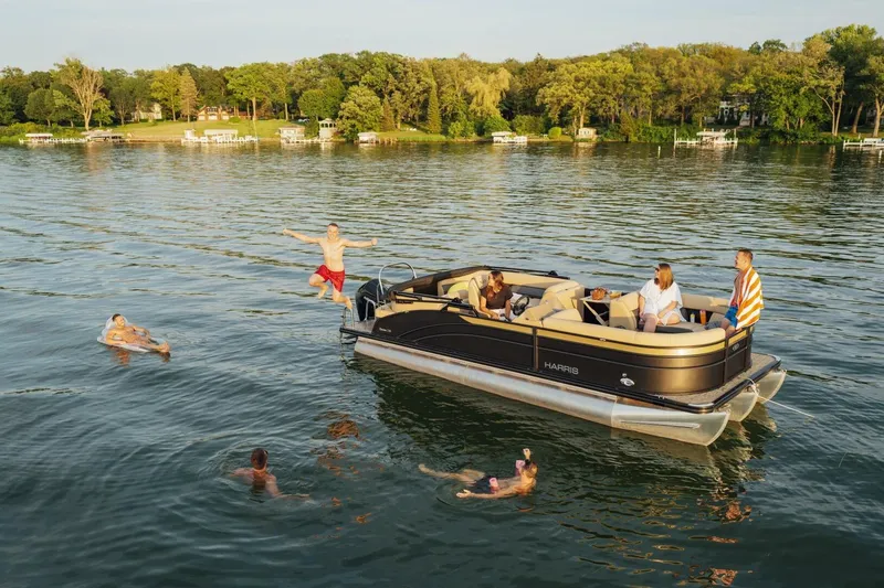 Slide: The Image of 2023 Harris Sunliner 230 Sport boat interior with steering wheel and control panel. - 9