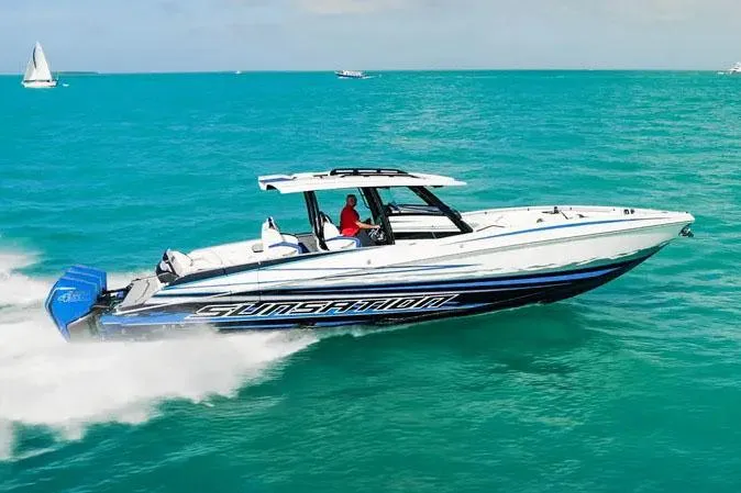 The Image of Manufacturer Provided Image: 2026 Sunsation 40 CCX speedboat cruising on turquoise water, showcasing sleek design and powerful engines. - 0
