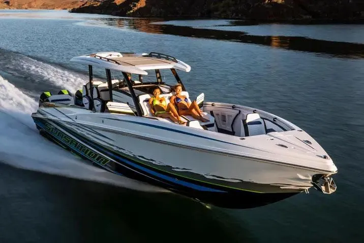 Slide: The Image of Manufacturer Provided Image: 2026 Sunsation 40 CCX speedboat cruising on a lake with passengers enjoying the ride. - 4