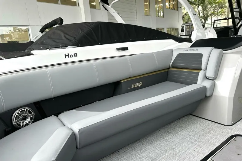 Slide: The Image of 2023 Harris Sunliner 250 Sport boat interior with plush seating and modern design. - 10
