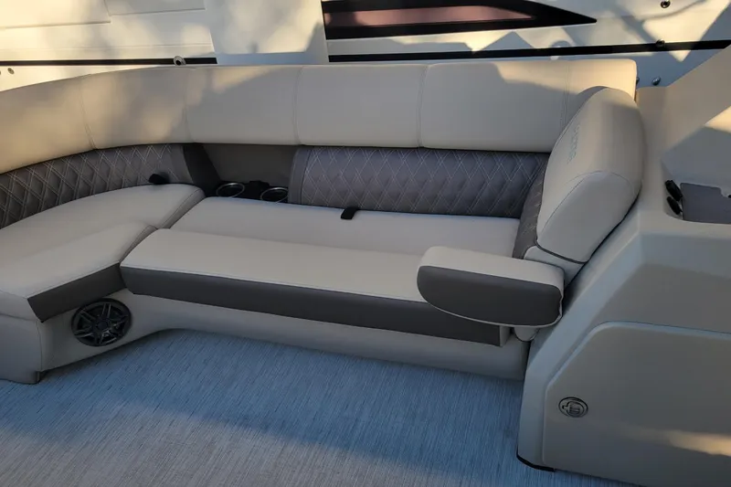 Slide: The Image of 2023 Harris Sunliner 250 Sport boat interior with luxurious seating and cup holders. - 15