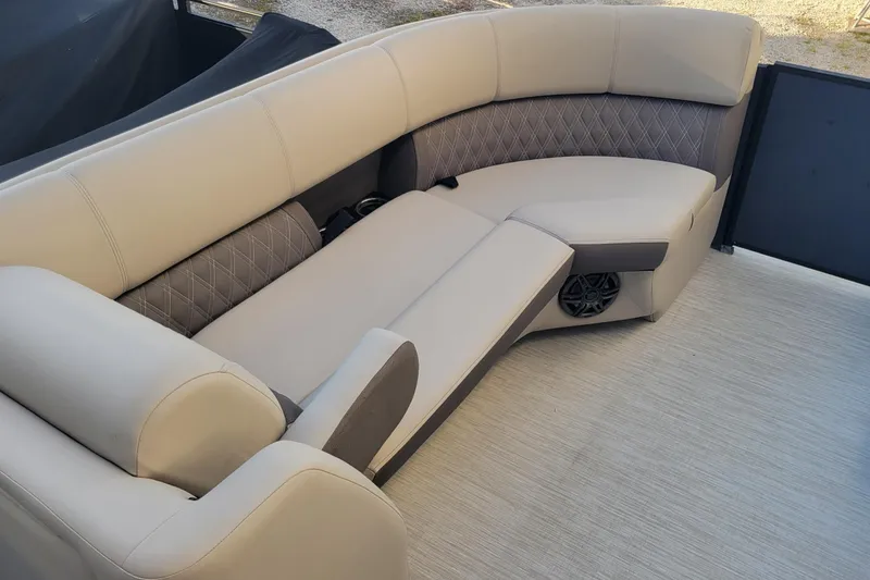 Slide: The Image of 2023 Harris Sunliner 250 Sport boat interior with luxurious seating and speaker system. - 16
