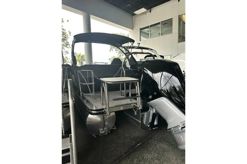 Slide: The Image of 2023 Harris Sunliner 250 Sport pontoon boat with sleek design and modern features. - 4