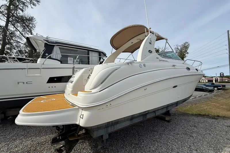 Slide: The Image of 2001 Sea Ray 280 Sundancer boat on display, side view with sleek design. - 1