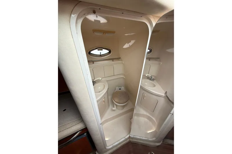 Slide: The Image of 2001 Sea Ray 280 Sundancer bathroom with sink, toilet, and oval window. - 15