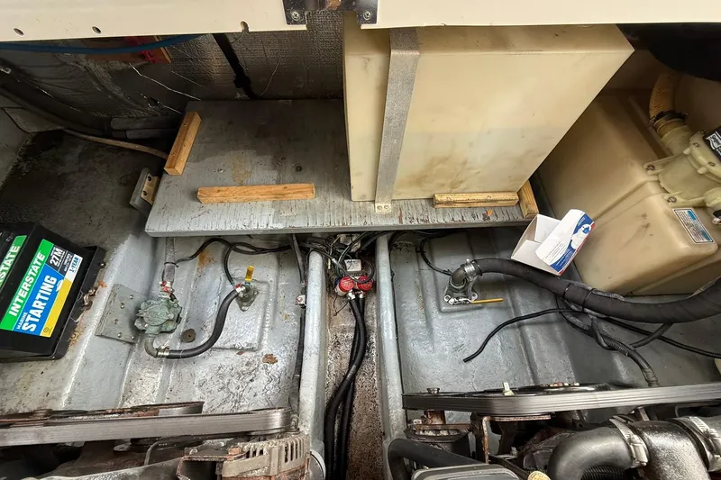 Slide: The Image of Engine compartment of a 2001 Sea Ray 280 Sundancer with visible battery and wiring. - 22