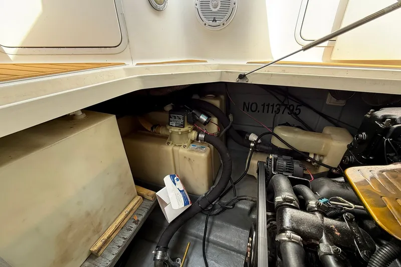 Slide: The Image of Engine compartment of 2001 Sea Ray 280 Sundancer boat, showing mechanical components and wiring. - 23