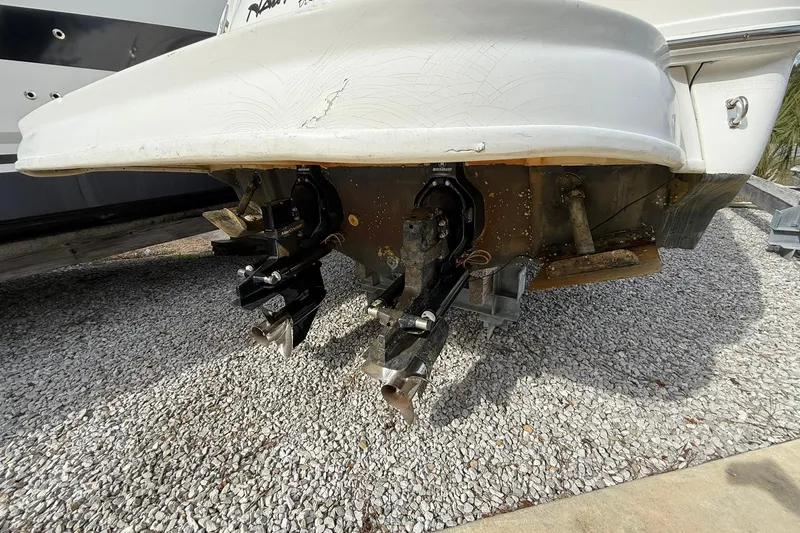 Slide: The Image of 2001 Sea Ray 280 Sundancer boat stern with dual outdrives on gravel surface. - 3