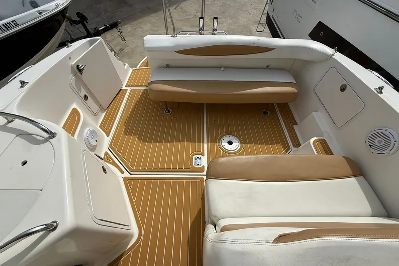Slide: The Image of 2001 Sea Ray 280 Sundancer boat interior with tan and white seating and teak-style flooring. - 5