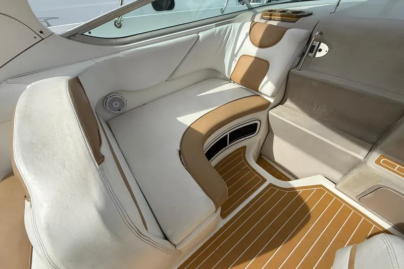 Slide: The Image of 2001 Sea Ray 280 Sundancer interior with white and tan seating, wood-patterned flooring. - 6