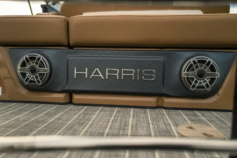 Slide: The Image of 2023 Harris Solstice 250 boat interior with speakers and logo detail. - 11