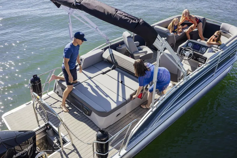 Slide: The Image of 2023 Harris Solstice 250 pontoon boat with people enjoying a sunny day on the water. - 5