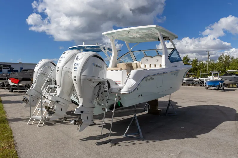Slide: The Image of 2026 Edgewater 262CX Crossover boat with dual Yamaha outboard engines on display. - 10