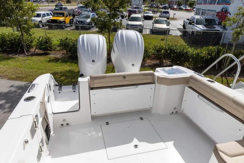 Slide: The Image of 2026 Edgewater 262CX Crossover boat interior with dual engines and seating area. - 11