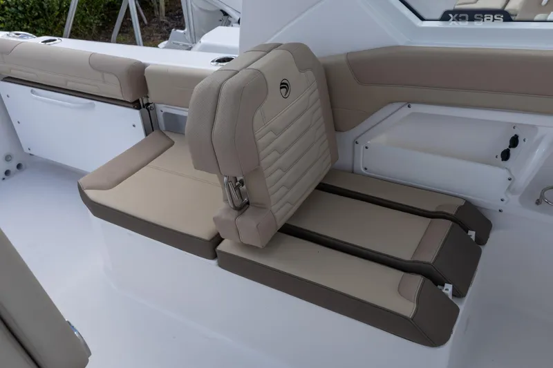 Slide: The Image of 2026 Edgewater 262CX Crossover boat interior with beige seating and modern design. - 15
