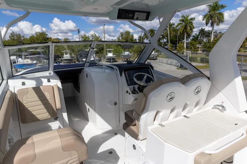 Slide: The Image of 2026 Edgewater 262CX Crossover boat interior with modern seating and steering console. - 3