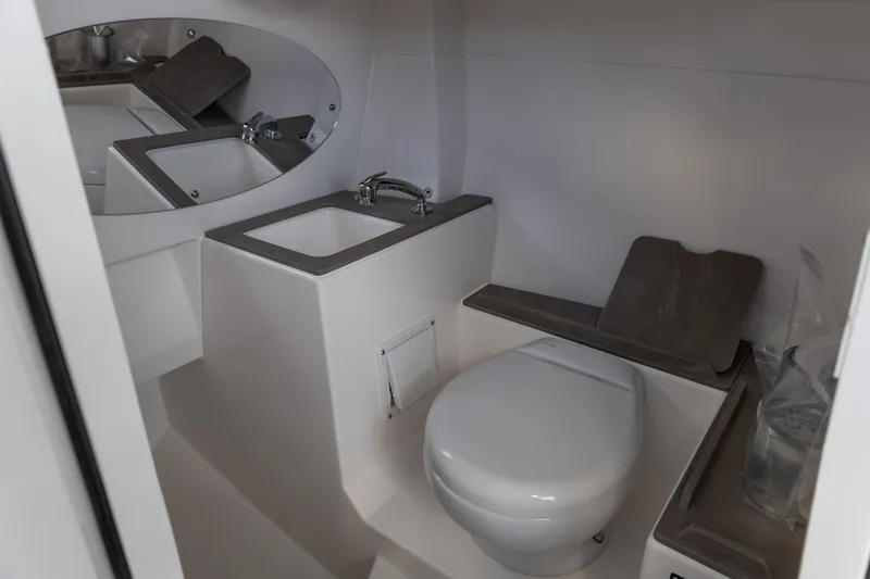 Slide: The Image of Modern bathroom in 2026 Edgewater 262CX Crossover boat, featuring sink and toilet. - 5