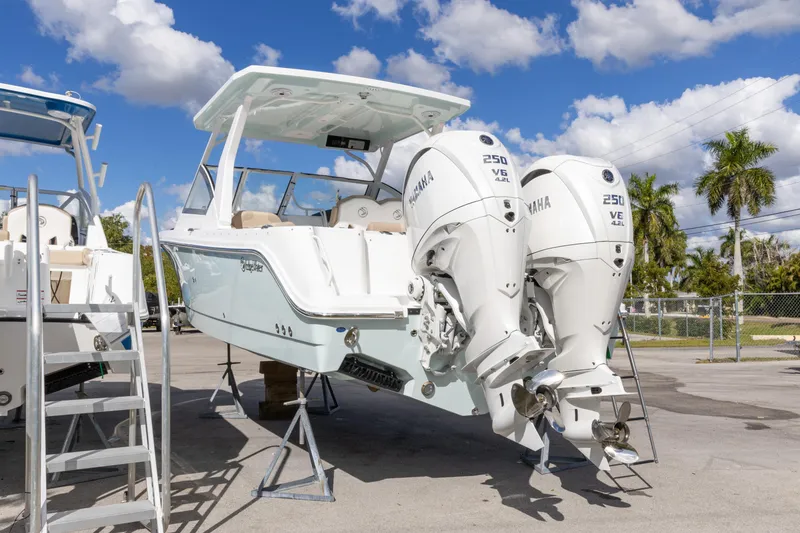Slide: The Image of 2026 Edgewater 262CX Crossover boat with twin Yamaha 250 engines, displayed outdoors. - 8