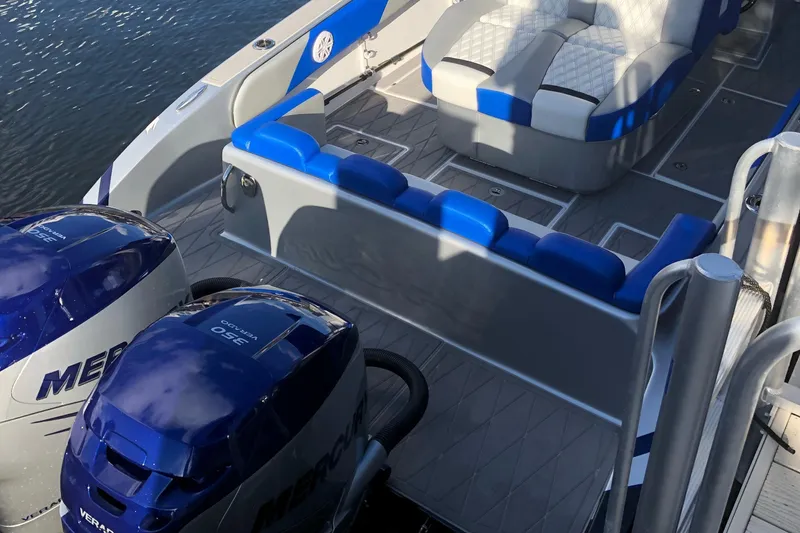 Slide: The Image of 2019 Statement Center Console boat with blue seating and Mercury engines. - 14