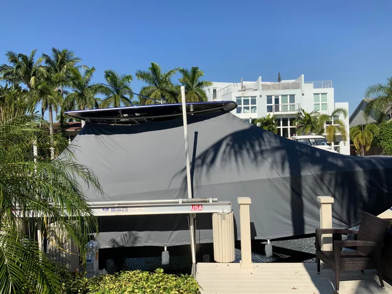 Slide: The Image of 2019 Statement Center Console boat covered at dock. - 15