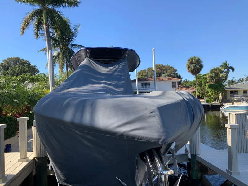 Slide: The Image of Covered 2019 Statement Center Console boat at a sunny dock. - 16