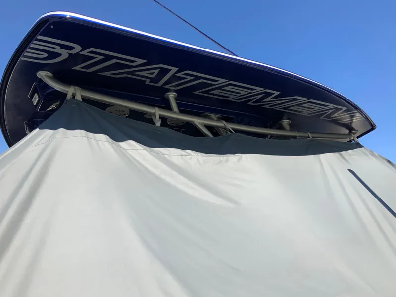 Slide: The Image of 2019 Statement Center Console boat with cover, blue sky. - 17