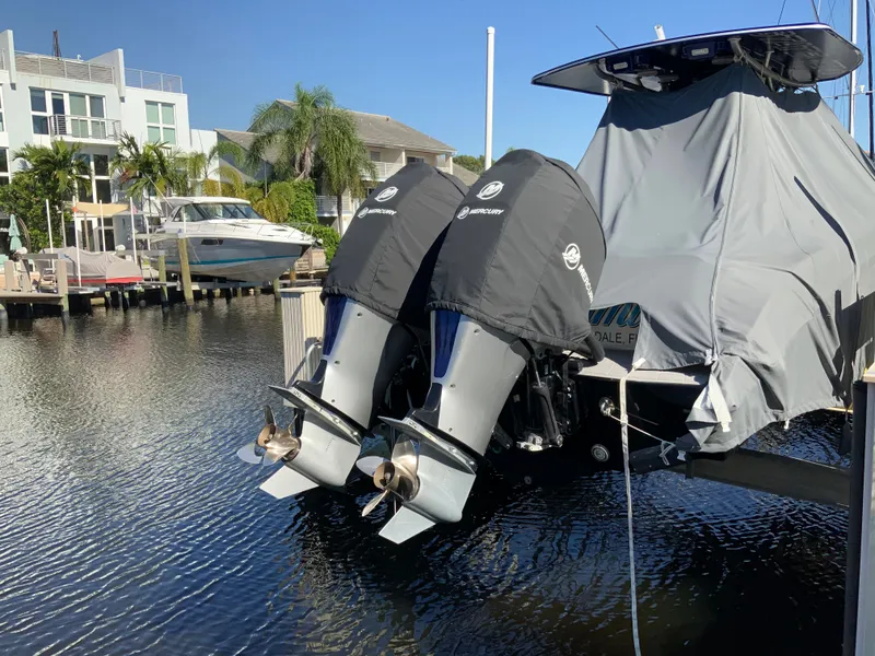 Slide: The Image of 2019 Statement Center Console with covered engines at the dock. - 19
