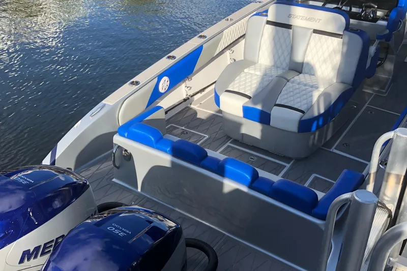 Slide: The Image of 2019 Statement Center Console boat with blue and white seating. - 2