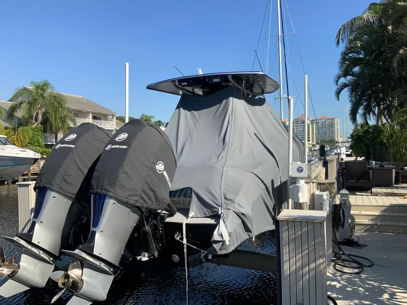 Slide: The Image of 2019 Statement Center Console boat covered at dock. - 20
