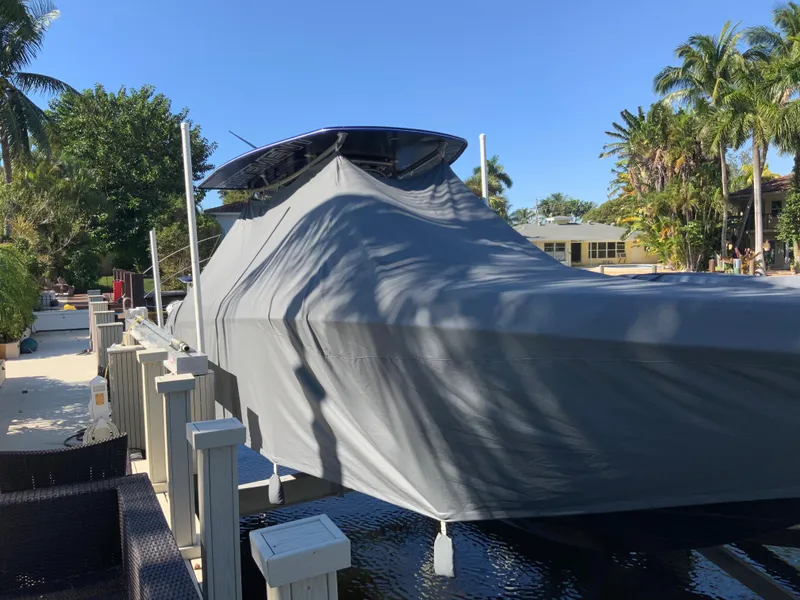 Slide: The Image of 2019 Statement Center Console boat covered at dock. - 21