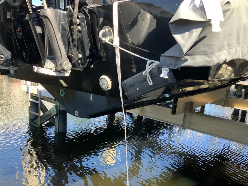 Slide: The Image of 2019 Statement Center Console boat at dock, partially covered. - 22