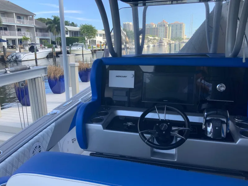 Slide: The Image of Interior view of a 2019 Statement Center Console boat in a marina. - 6