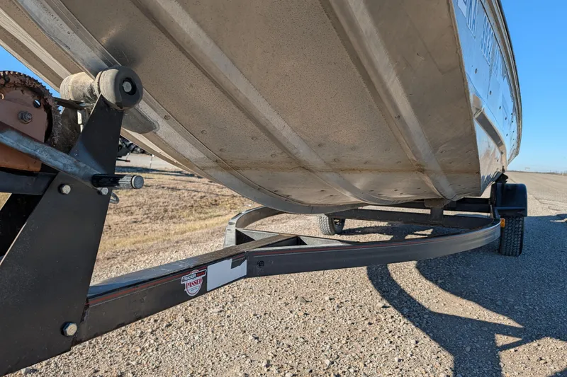 Slide: The Image of 1988 Bass Tracker Pro 17 boat on trailer, showing underside and wheel detail. - 11
