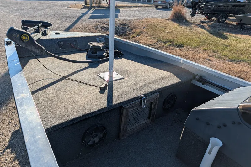 Slide: The Image of 1988 Bass Tracker Pro 17 boat interior with trolling motor and carpeted deck. - 13