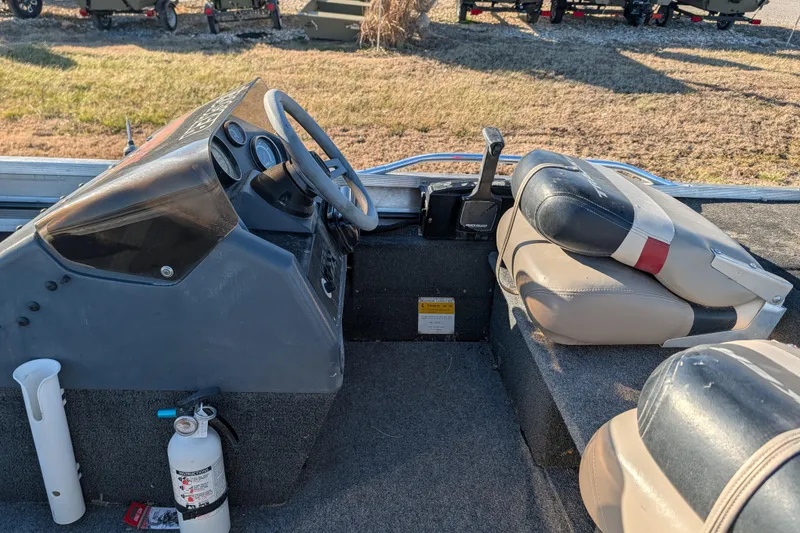 Slide: The Image of 1988 Bass Tracker Pro 17 boat interior with steering wheel and seats. - 14