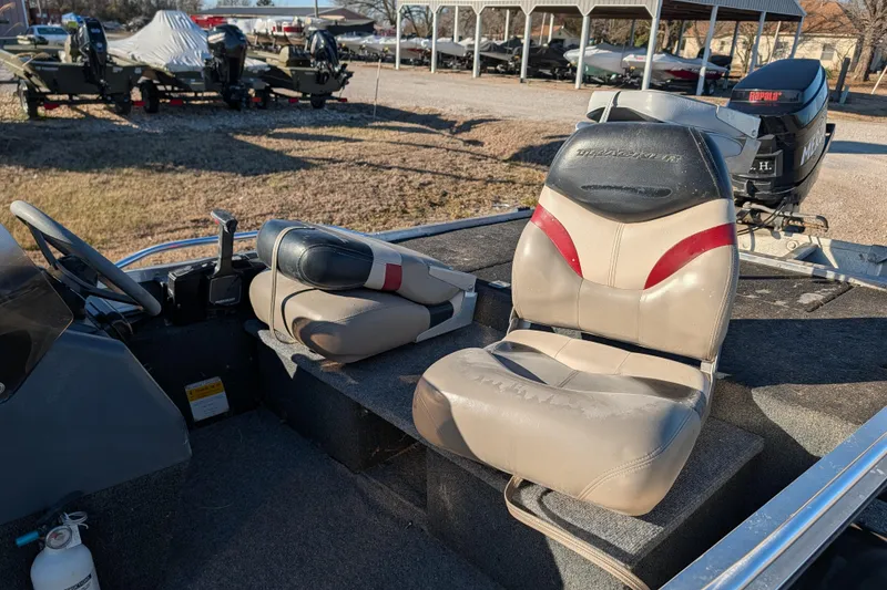 Slide: The Image of 1988 Bass Tracker Pro 17 boat interior with seats and steering wheel. - 17