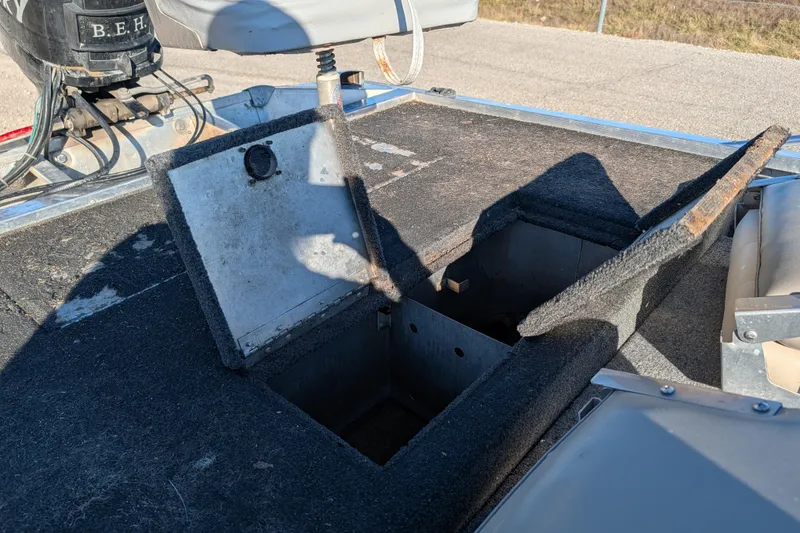 Slide: The Image of 1988 Bass Tracker Pro 17 boat with open storage compartment and motor in view. - 18