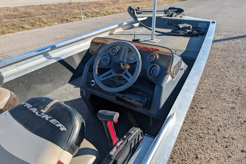 Slide: The Image of 1988 Bass Tracker Pro 17 boat interior with steering wheel and dashboard controls. - 19