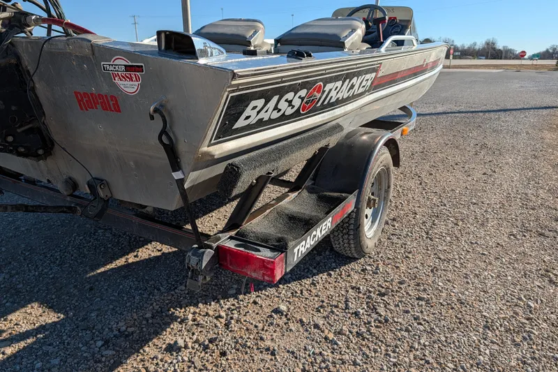 Slide: The Image of 1988 Bass Tracker Pro 17 boat on trailer, parked on gravel surface. - 6