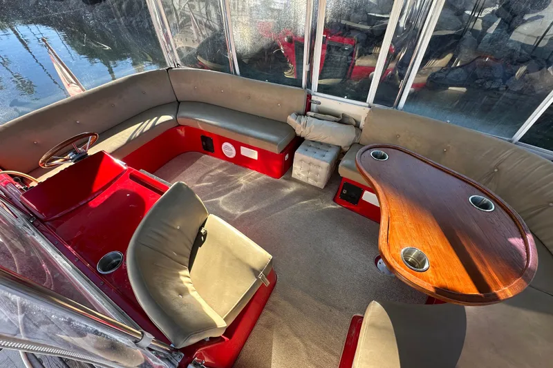 Slide: The Image of Interior of a 2006 Duffy Cat 16 boat with red and beige seating. - 11