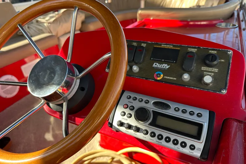 Slide: The Image of Steering wheel and control panel of a 2006 Duffy Cat 16 boat. - 13