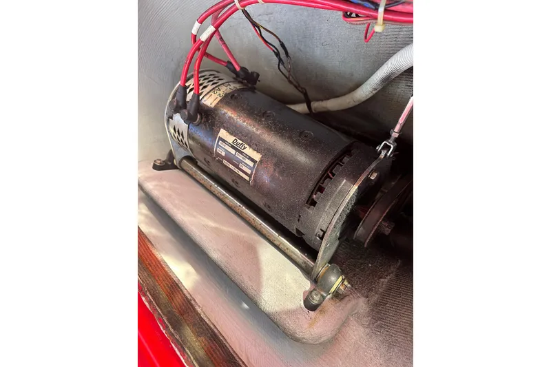 Slide: The Image of Electric motor inside a 2006 Duffy Cat 16 boat, with visible wiring and label. - 15
