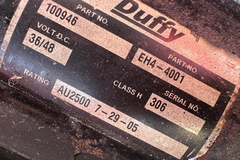 Slide: The Image of Label on a 2006 Duffy Cat 16, showing part and serial numbers. - 16